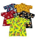 Five short-sleeve Hawaiian-style camp shirtsThe shirts feature various tropical prints including pineapples, flowers, and leaves in bright colors like yellow, red, blue, black, and orange.