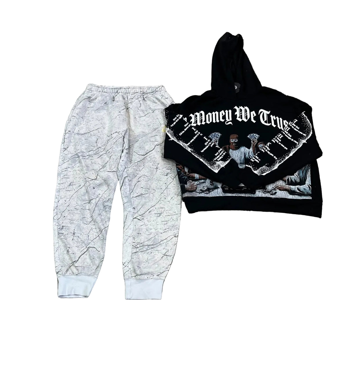 A two-piece streetwear outfit featuring light gray and white marble-patterned jogger pants and a black cropped hoodie with a large white 'Money We True' gothic text graphic and a classical painting print.