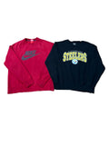 Two sweatshirts a red Nike sweatshirt on the left and a black Pittsburgh Steelers sweatshirt on the right. Bare feet are visible at the bottom edge, and other folded clothes appear at the top and bottom right.