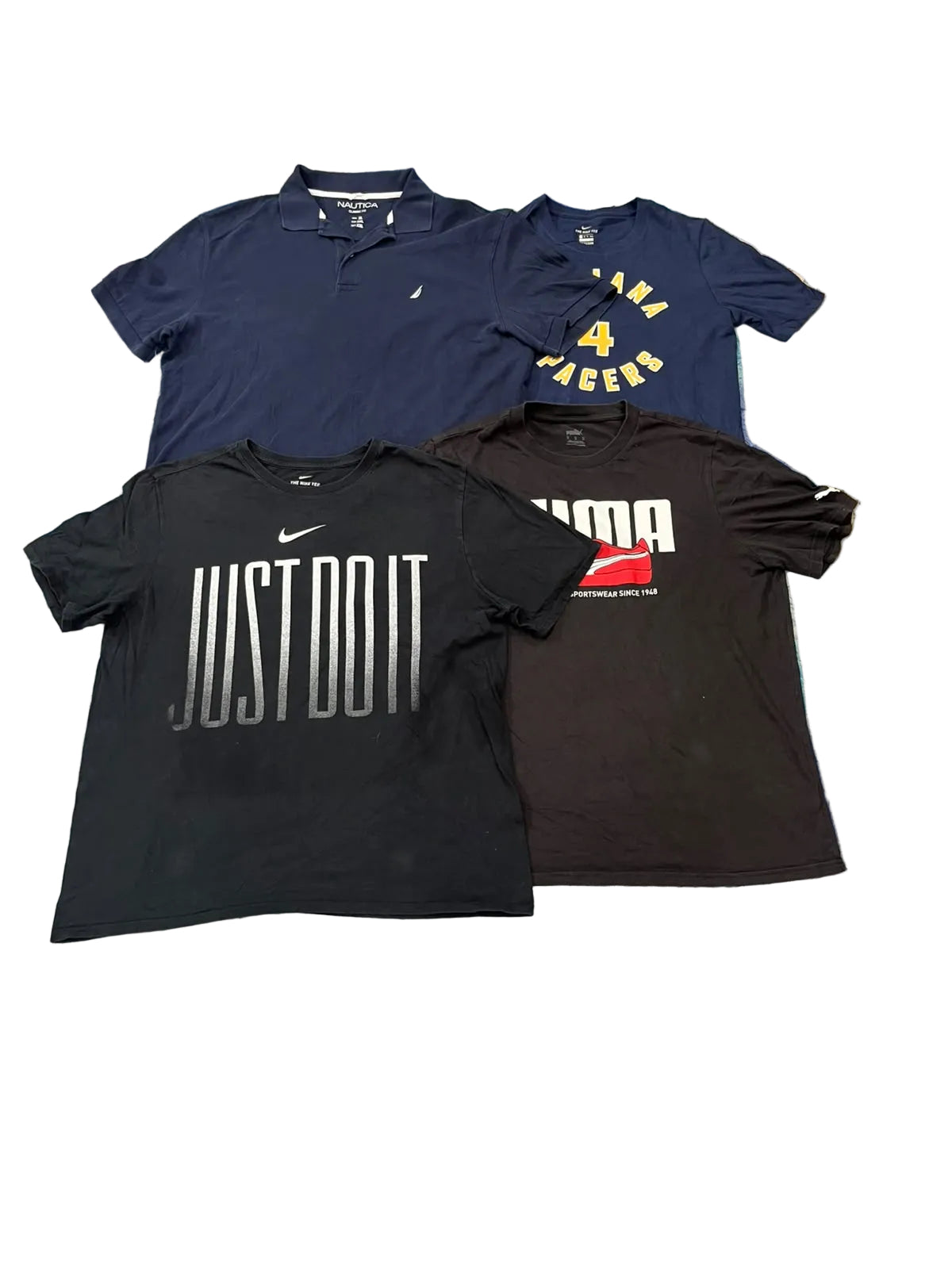 Four Nike athletic shirts in navy, yellow, black, and dark brown