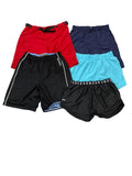 Four pairs of athletic shorts in red, navy, black, and light blue, . Under Armour branding is visible on the waistbands.