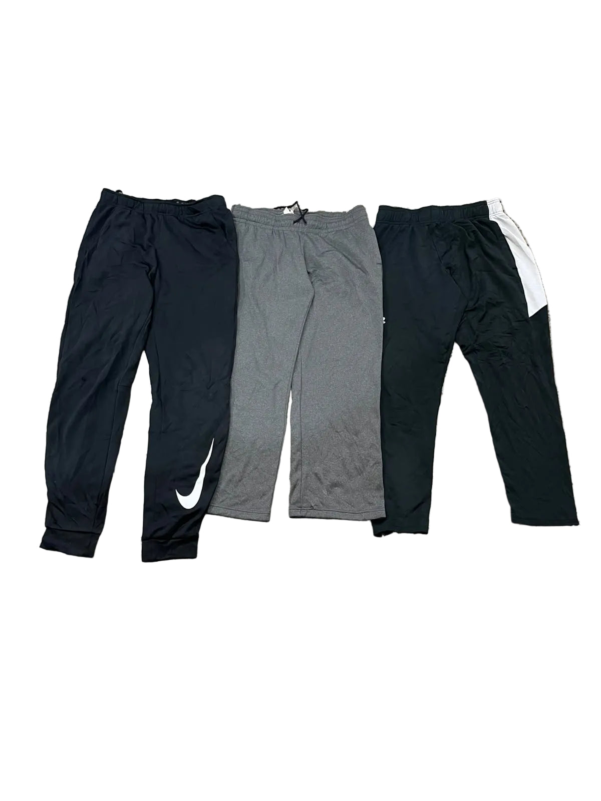 Three pairs of athletic sweatpants one black with a white Nike swoosh, one heather gray, and one black with a white side stripe.