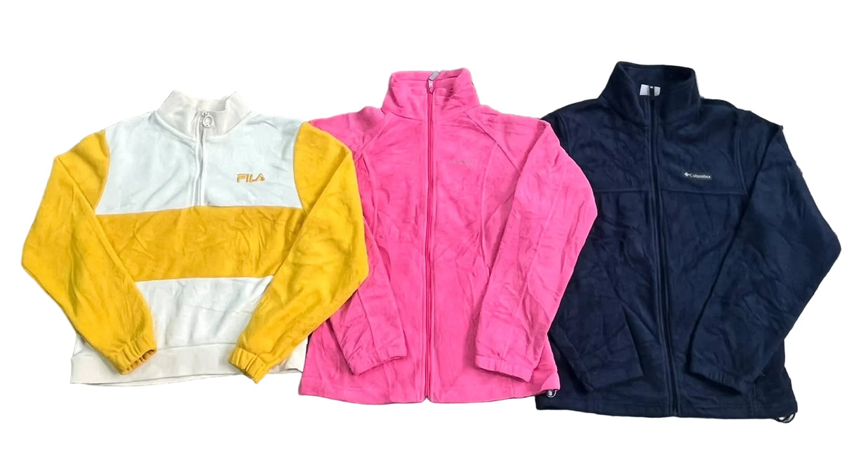 Three vintage zip-up jackets a white and yellow Fila jacket on the left, a bright pink jacket in the center, and a dark navy jacket on the right.