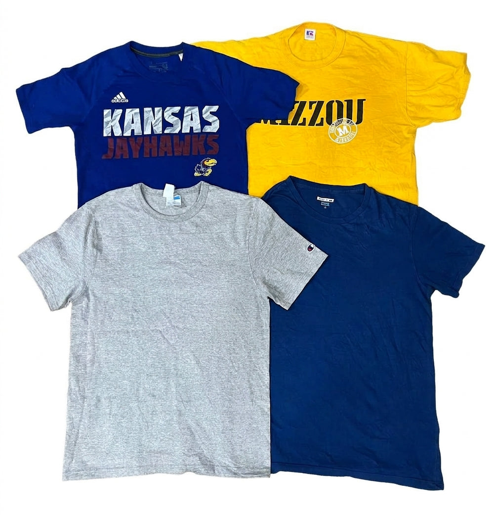 Four vintage short-sleeve crewneck t-shirts arranged in a 2x2 grid on a white background: a blue Adidas Kansas Jayhawks shirt, a yellow Missouri Tigers shirt, a heather gray Champion shirt, and a solid navy blue shirt.
