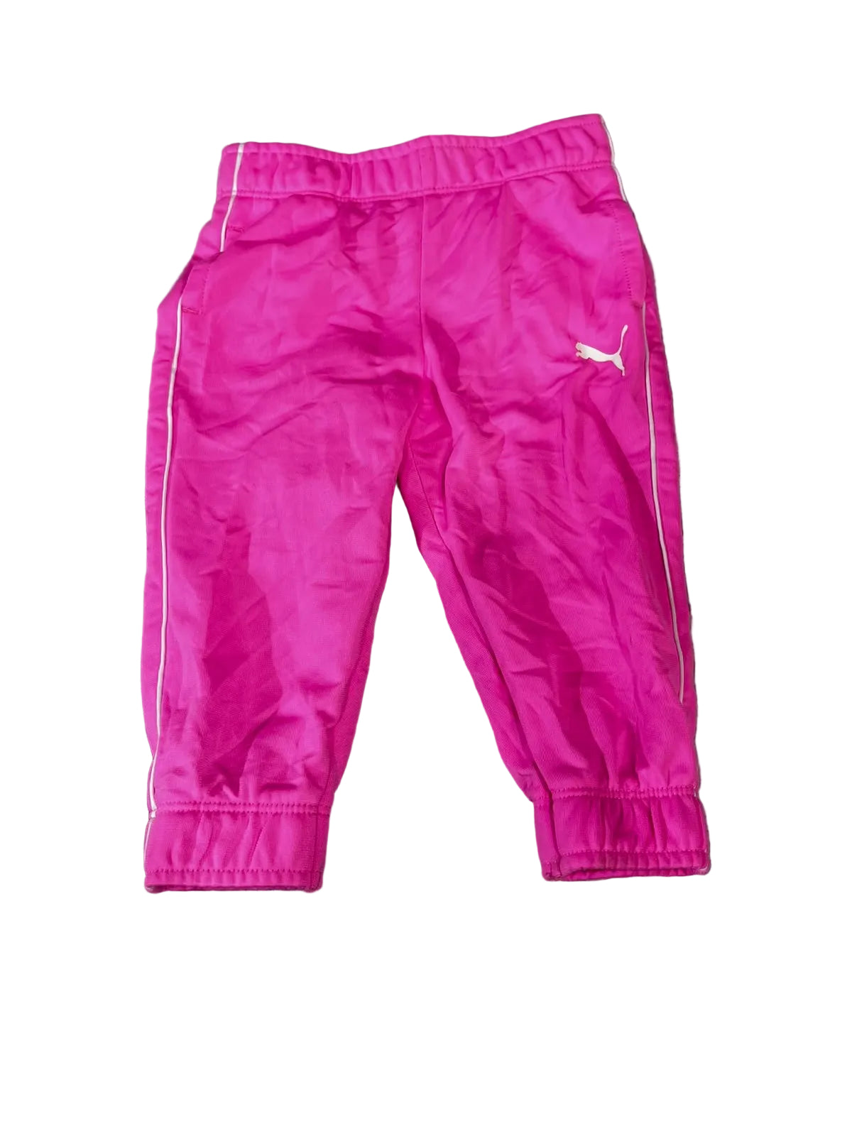Bright pink Puma track pants with white side stripes and a white Puma logo,