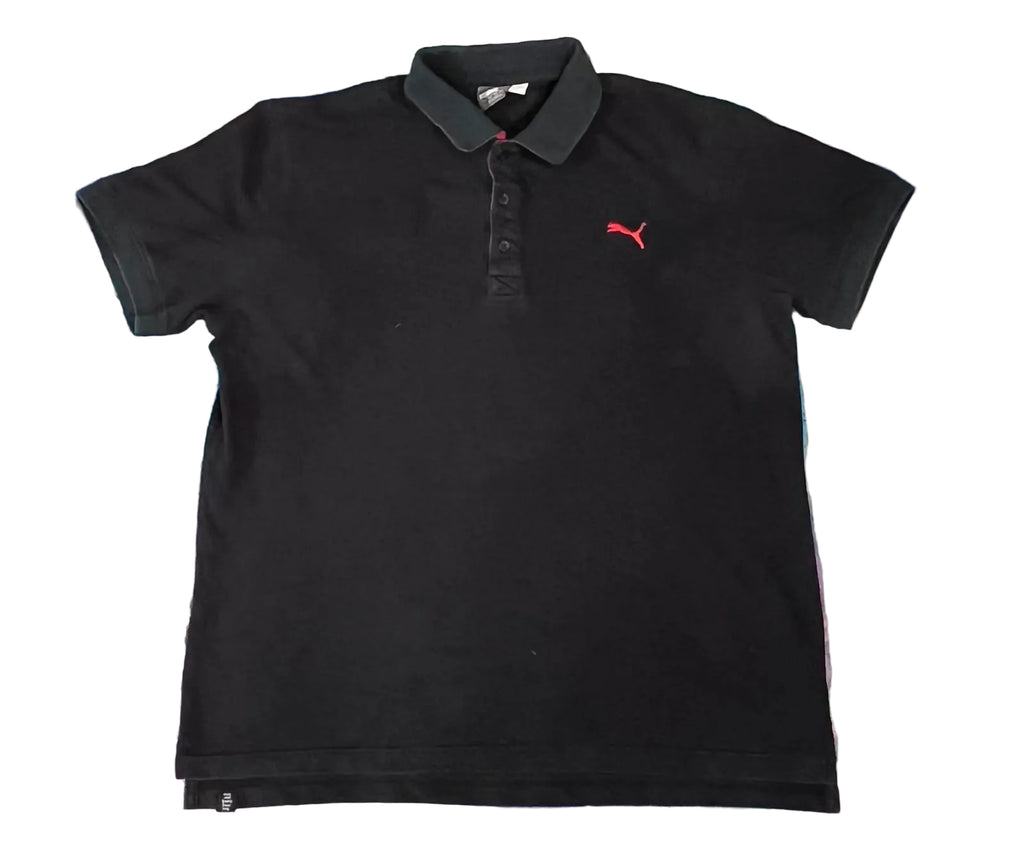 A black Puma short-sleeve polo shirt with a red logo on the left ches