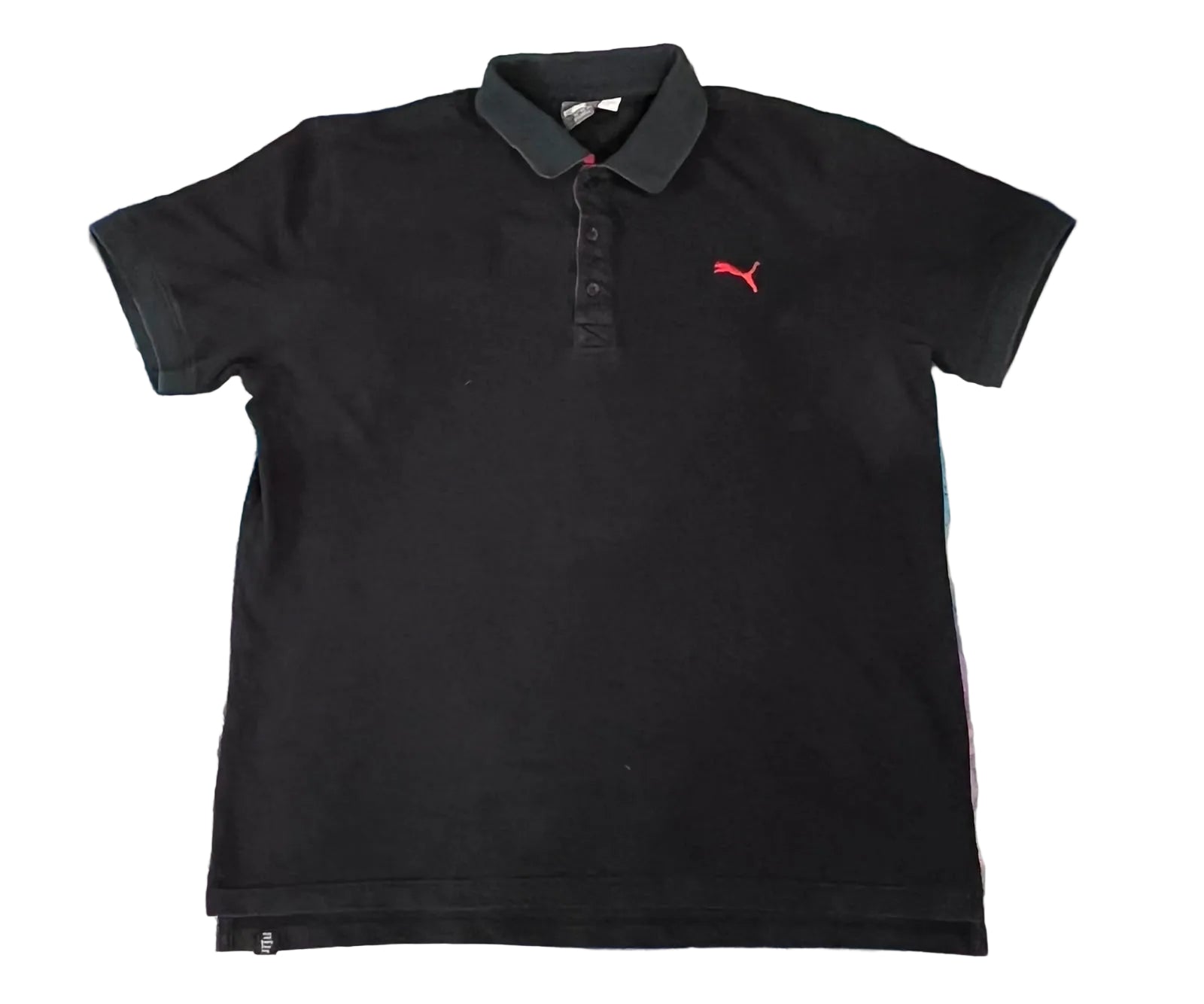 A black Puma short-sleeve polo shirt with a red logo on the left ches
