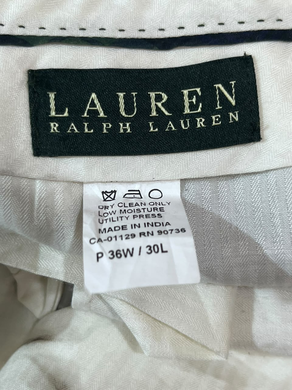 Close-up of a white or off-white Lauren Ralph Lauren garment showing the black brand label and care tag.