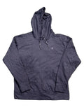 A black Champion pullover hoodie is with bare feet visible at the bottom edge of the frame.