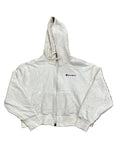 A cream-colored Champion zip-up hoodie . The hoodie features the classic embroidered Champion logo on the left chest.