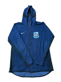 A navy blue Nike zip-up hoodie with Manchester City crest on the chest,