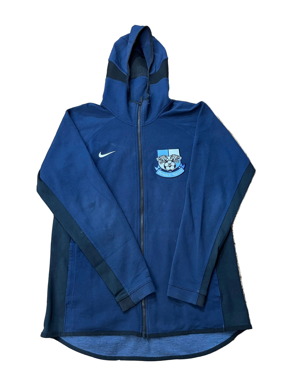 A navy blue Nike zip-up hoodie with Manchester City crest on the chest,