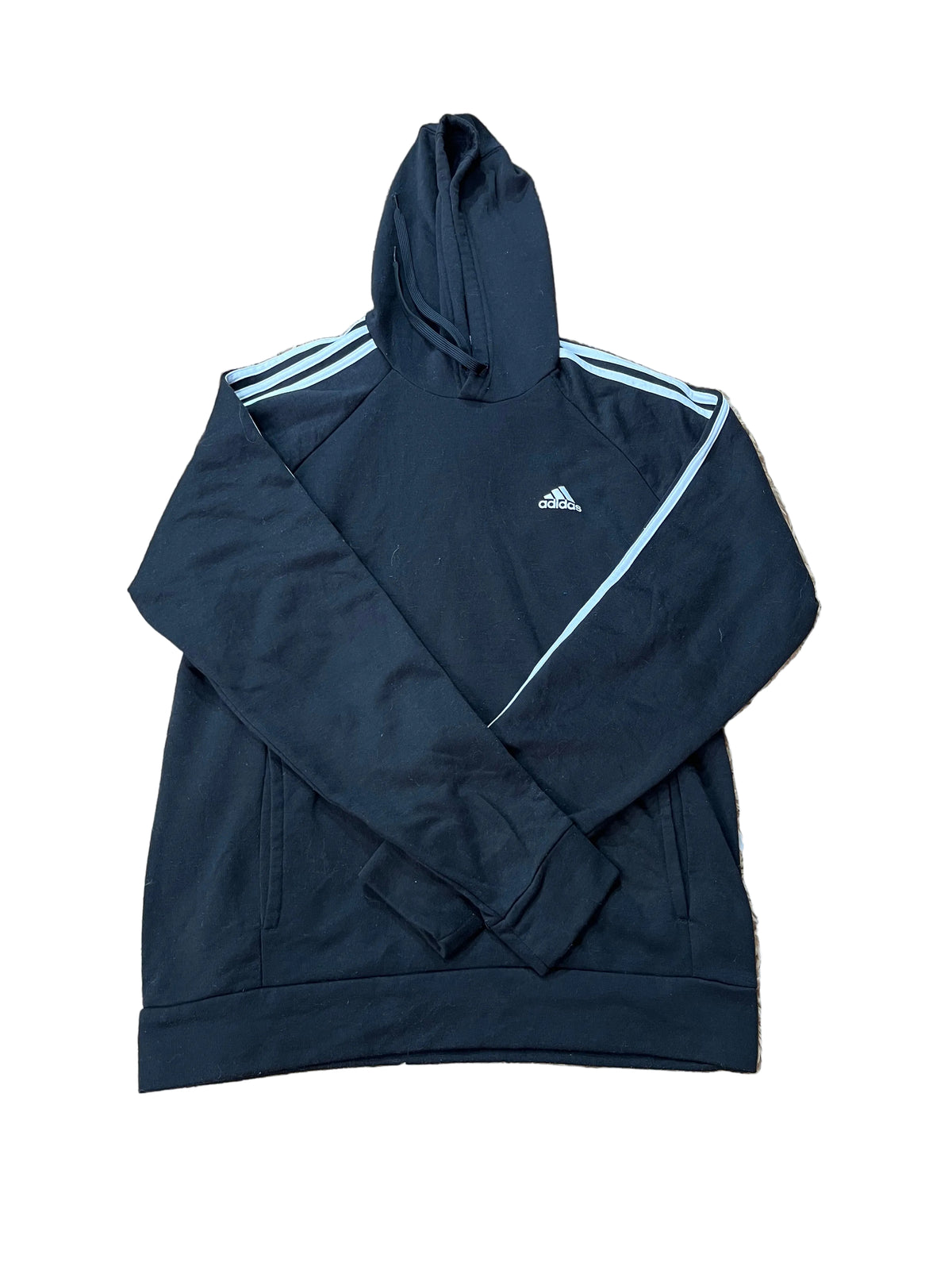 A black Adidas track jacket with light blue stripes on the shoulders and a diagonal stripe detail on the chest,