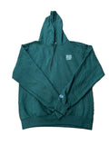 A dark green Champion pullover hoodie with a small white chest logo and a blue/red Champion emblem on the left sleeve, 