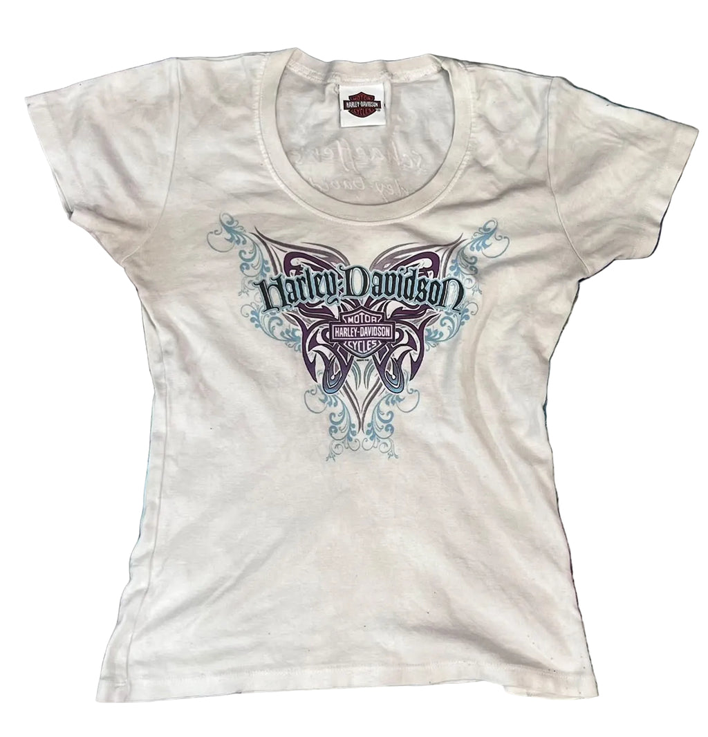 A white Harley-Davidson short-sleeve t-shirt with a large graphic on the front The graphic features a purple and blue butterfly design with the Harley-Davidson logo in the center.