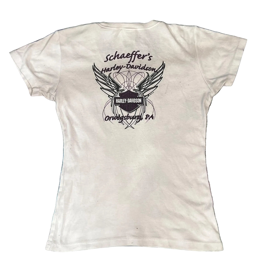 A white short-sleeve t-shirt . The back of the shirt features a black graphic print of a winged motorcycle helmet with the Harley-Davidson logo and the text 'schaeffer's Harley-Davidson' and 'Orlando, FL'.