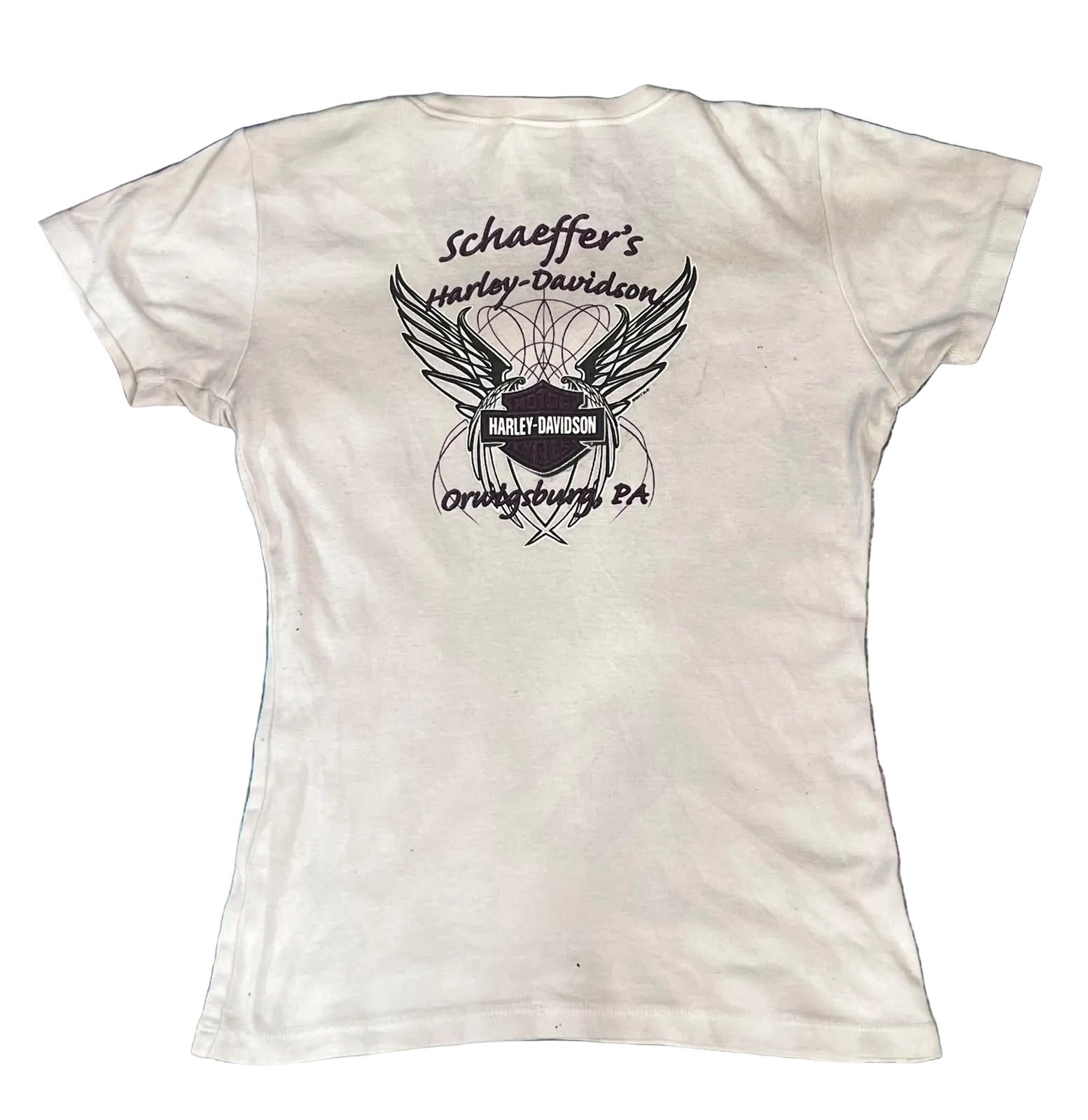 A white short-sleeve t-shirt . The back of the shirt features a black graphic print of a winged motorcycle helmet with the Harley-Davidson logo and the text 'schaeffer's Harley-Davidson' and 'Orlando, FL'.