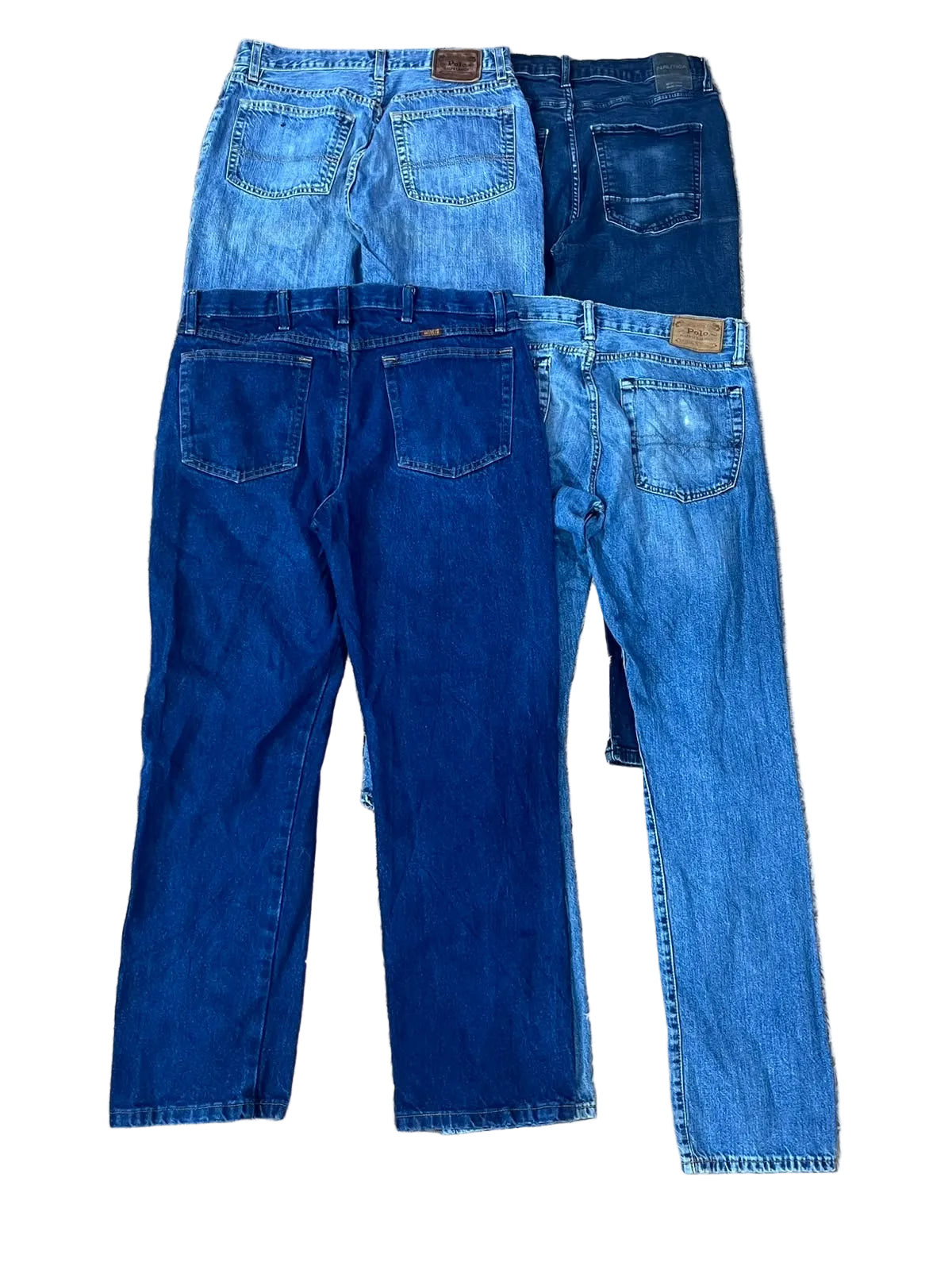 Three pairs of jeans in different blue washes showing the back pockets and waistbands.