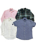 Four men's button-down shirts : a light pink long-sleeve shirt, a green and navy plaid long-sleeve shirt, an off-white long-sleeve shirt with a small chest logo, and a blue-and-white gingham short-sleeve shirt.