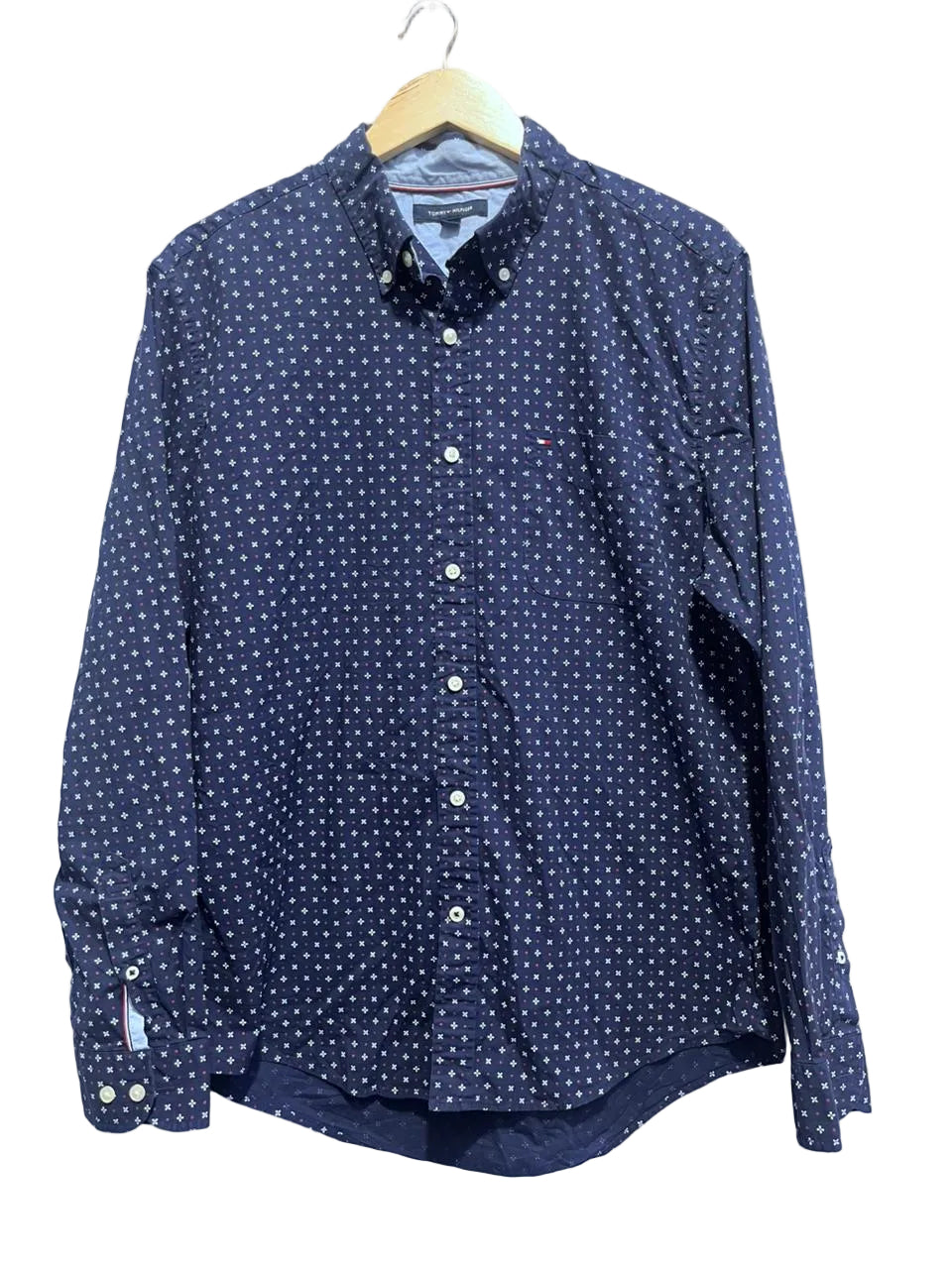 Tommy hilfiger navy blue shirt with white polka dots on a hanger against a white background