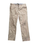 A pair of beige chino pants on a white plain background 