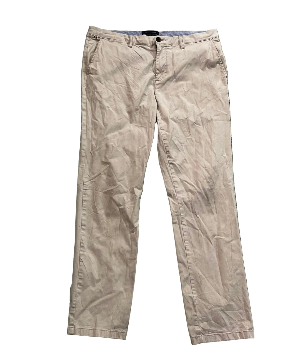 A pair of beige chino pants on a white plain background 