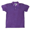 A purple short-sleeve polo shirt with a three-button placket and a small embroidered Tommy Hilfiger flag logo on the left chest, on a white plain background 