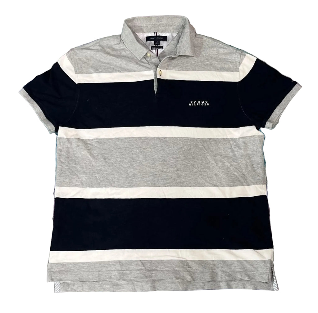 A short-sleeve striped polo shirt with horizontal bands of navy blue, light gray, and white, featuring a small white embroidered logo on the left chest. 