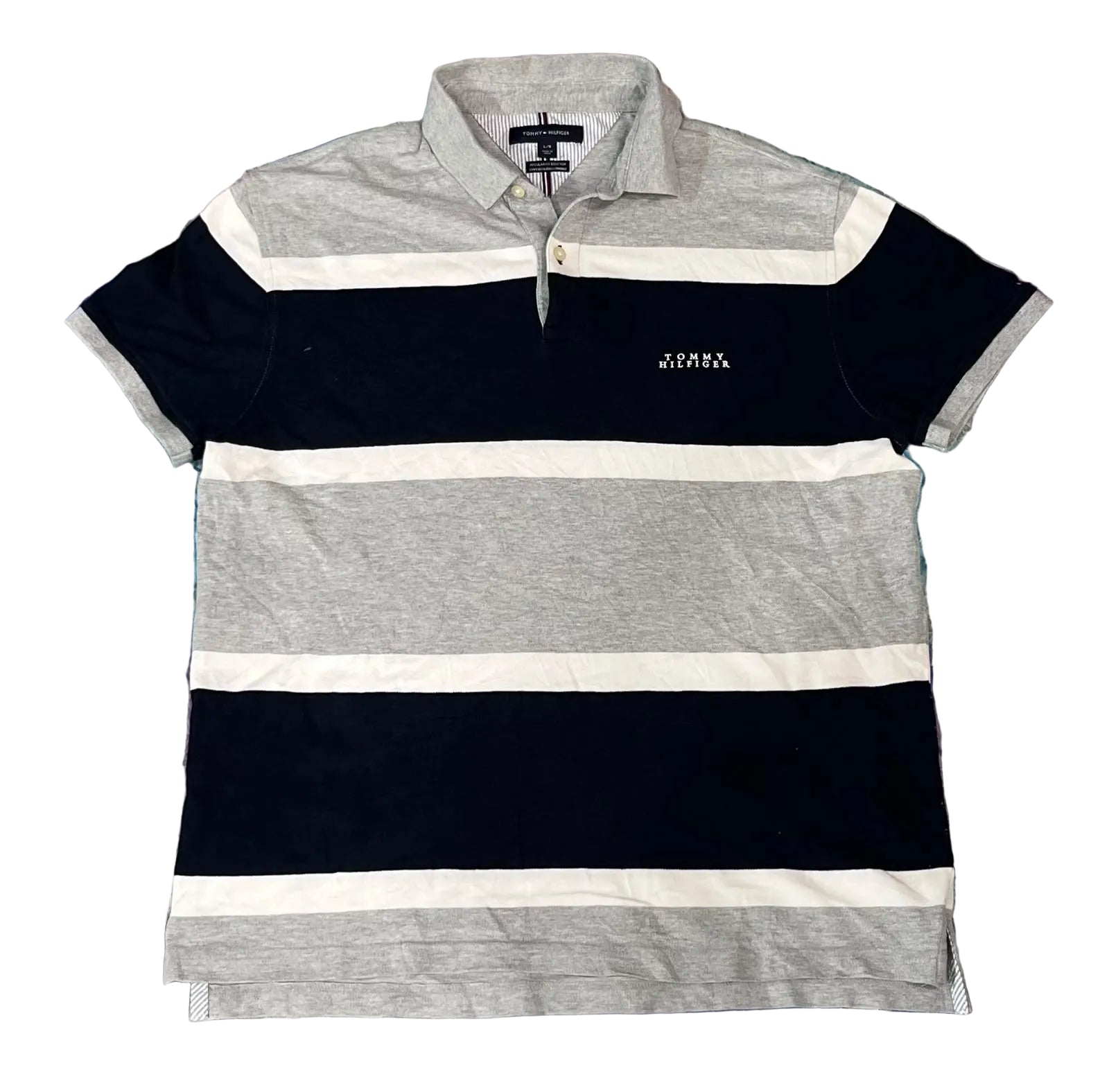 A short-sleeve striped polo shirt with horizontal bands of navy blue, light gray, and white, featuring a small white embroidered logo on the left chest. 
