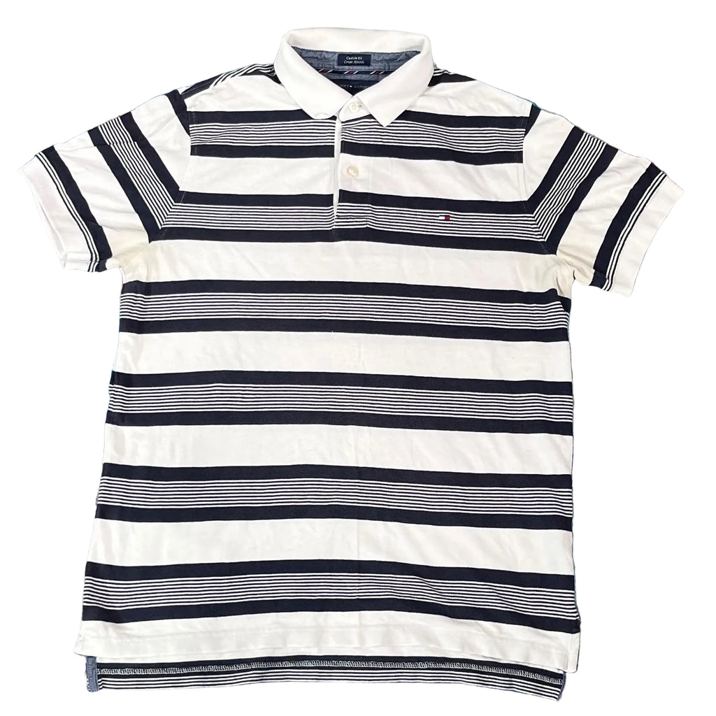A Tommy Hilfiger striped polo shirt with horizontal navy, white, and gray stripes, 