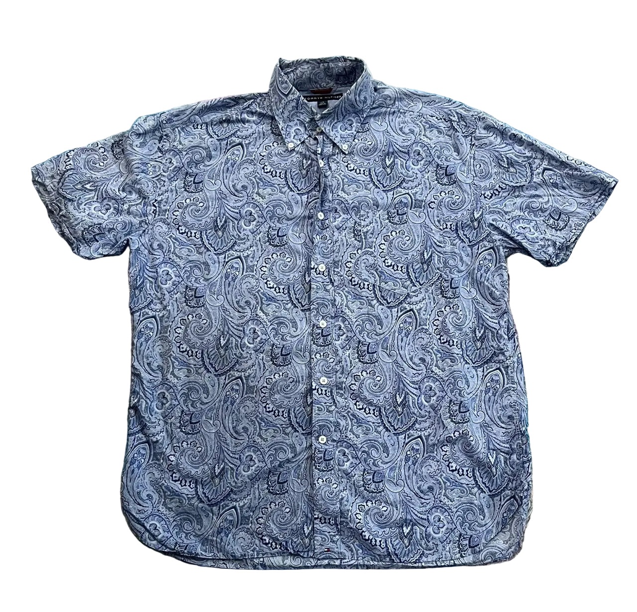 A short-sleeve button-up shirt with a blue and white paisley pattern,