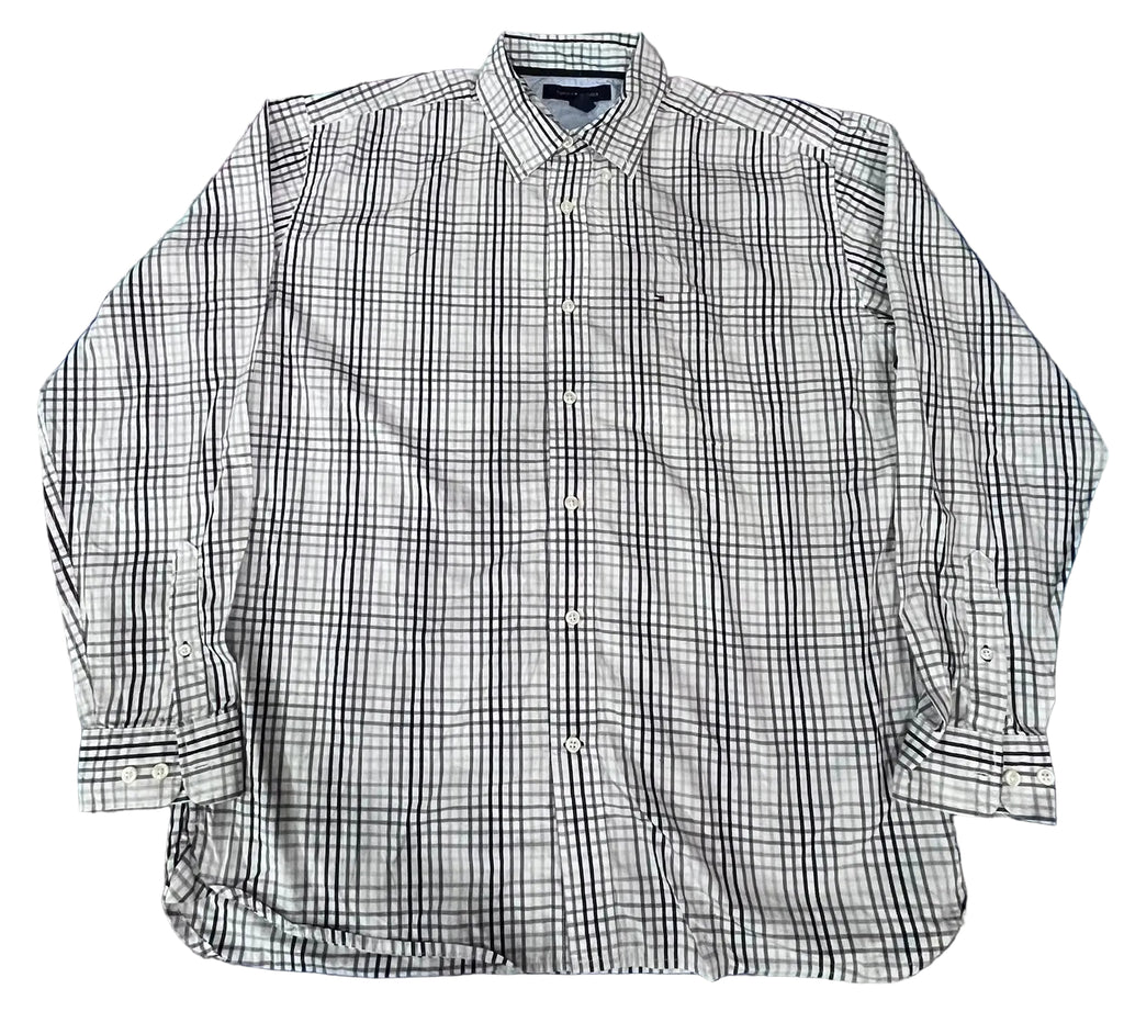 A long-sleeve button-up shirt with a black and white plaid pattern