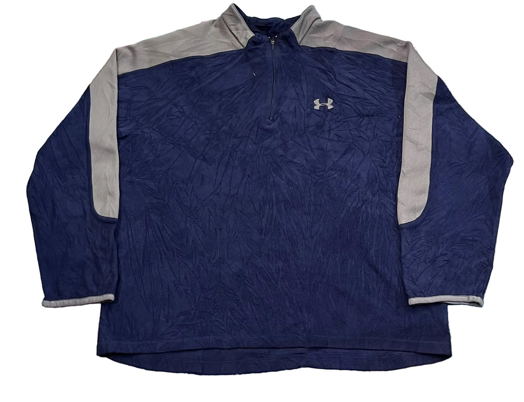 A navy blue Under Armour quarter-zip pullover jacket with gray shoulder and sleeve panels,