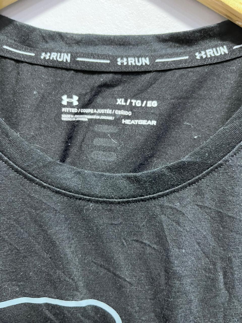 Black Under Armour shirt with 'RUN' and size label on a white background