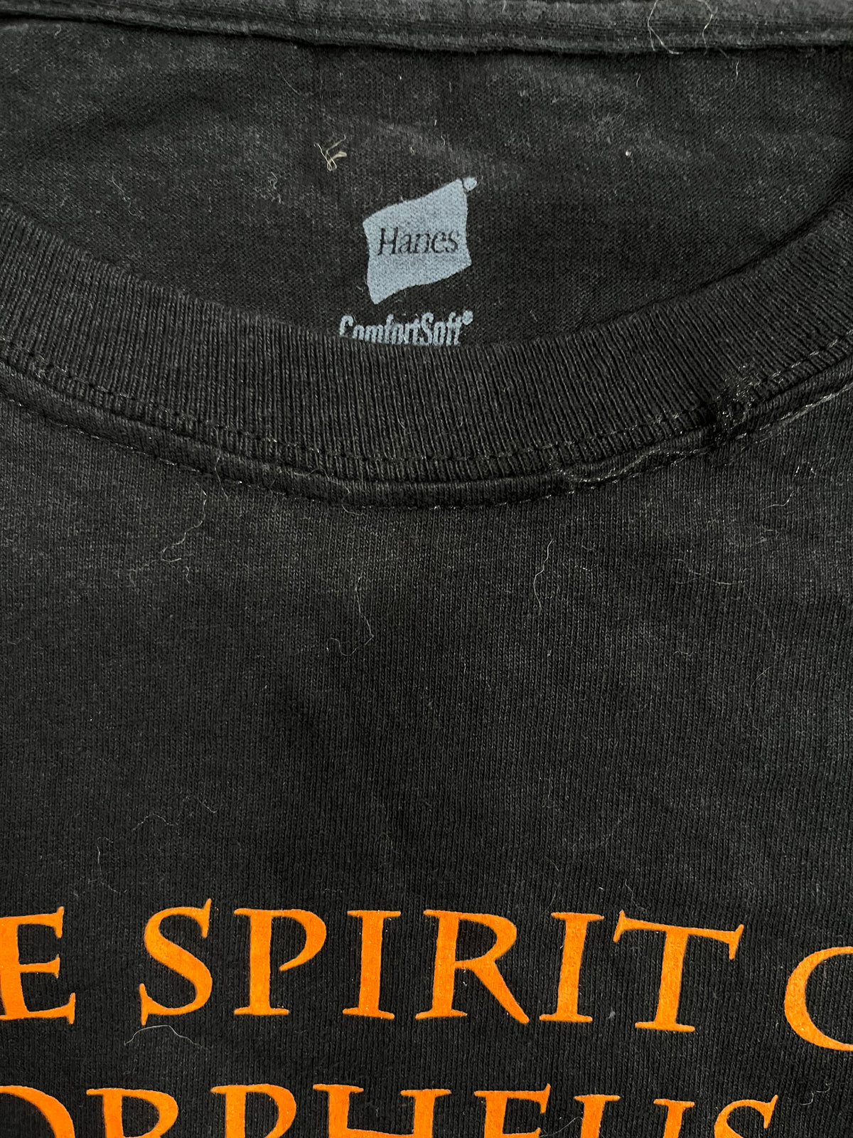 Close-up of a black Hanes ComfortSoft t-shirt showing the inner neck label and orange printed text at the bottom.