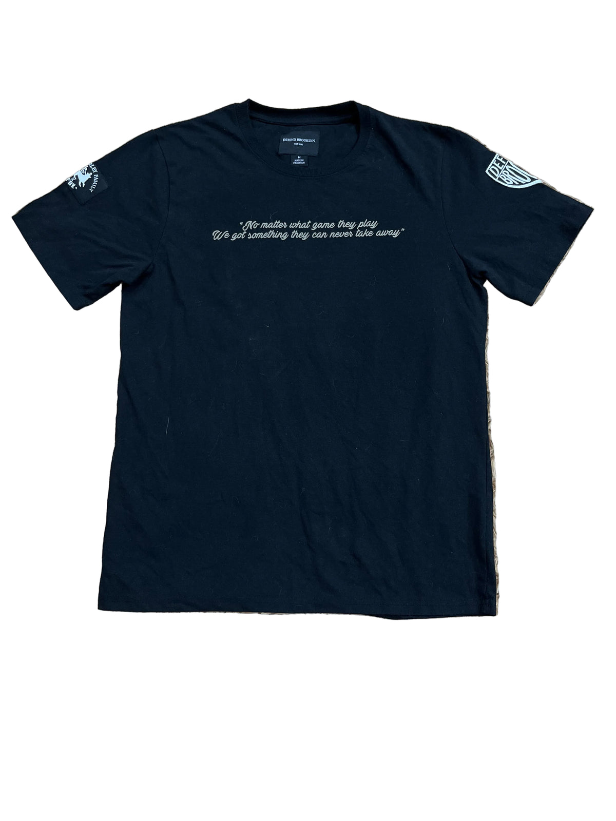 A black short-sleeve t-shirt with white text on the chest and white graphic prints on both sleeves,