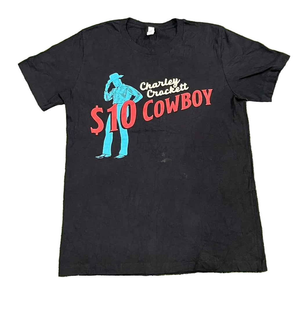 A black short-sleeve graphic t-shirt  The shirt features a graphic of a cowboy silhouette in blue, with the text 'Charley Crockett $10 COWBOY' in red and white.