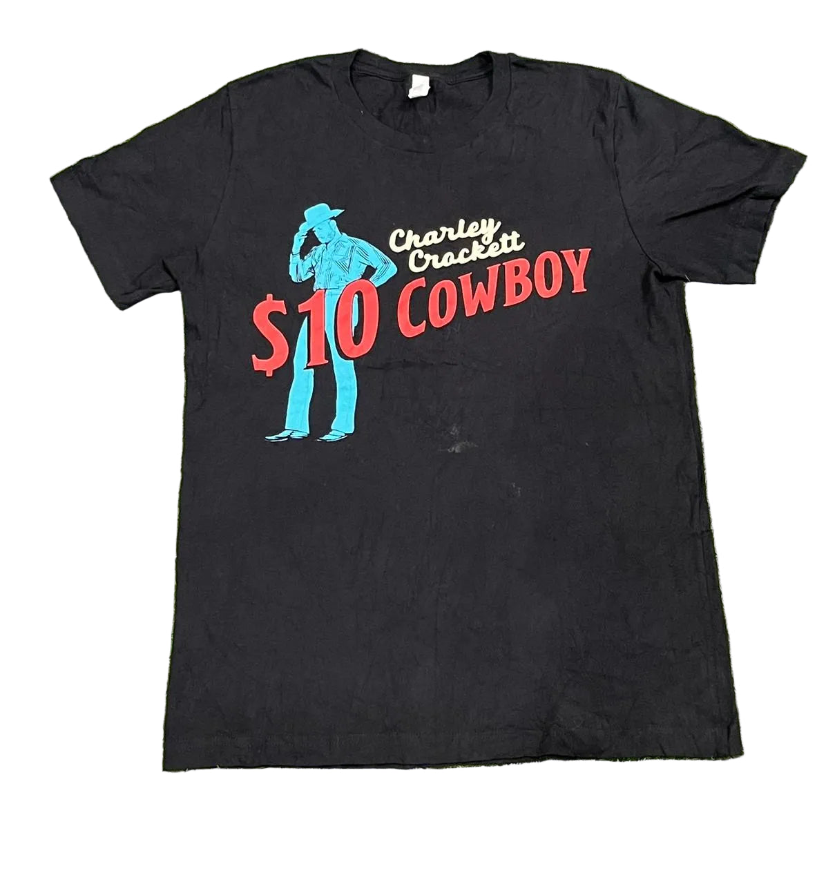 A black short-sleeve graphic t-shirt  The shirt features a graphic of a cowboy silhouette in blue, with the text 'Charley Crockett $10 COWBOY' in red and white.