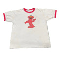 White t-shirt with red trim featuring a red character on a white background