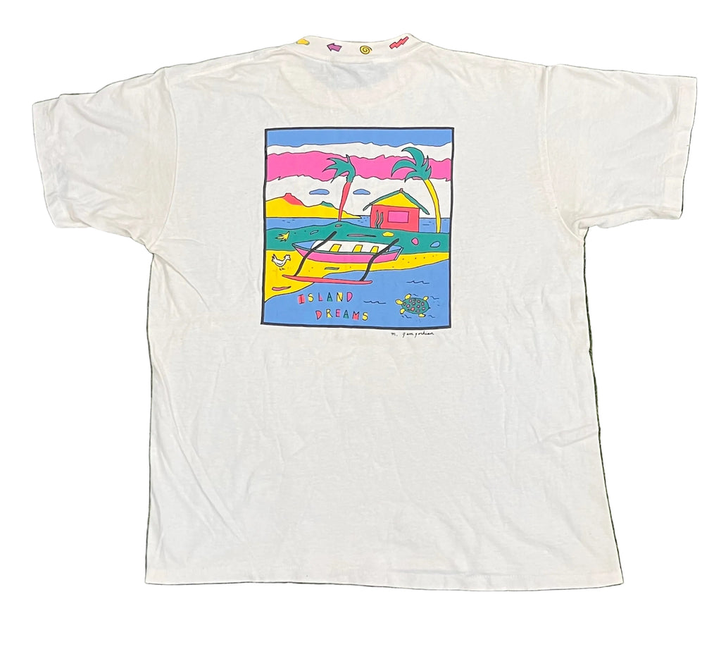 A white short-sleeve graphic t-shirt laid flat on white background The front of the shirt features a colorful square graphic print depicting a tropical beach scene with palm trees, a boat, and the text 'ISLAND DREAMS'.