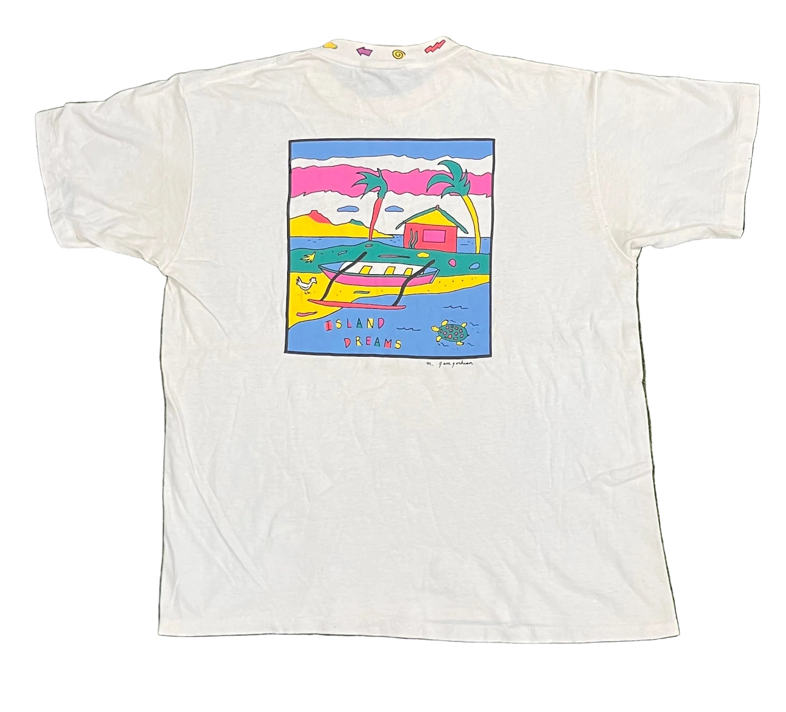 A white short-sleeve graphic t-shirt laid flat on white background The front of the shirt features a colorful square graphic print depicting a tropical beach scene with palm trees, a boat, and the text 'ISLAND DREAMS'.