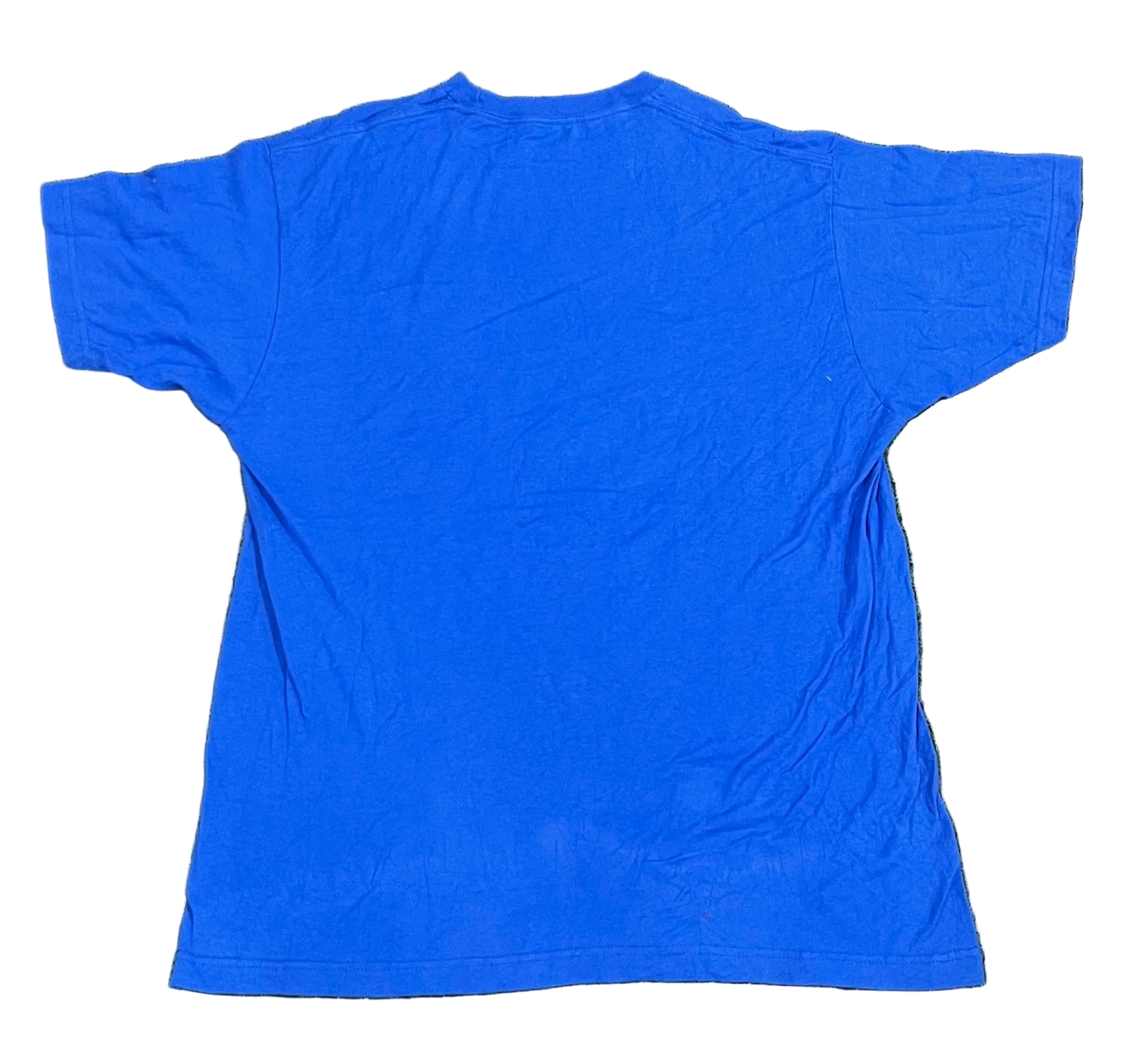 A bright blue short-sleeve t-shirt laid flat on  with background artificial turf.