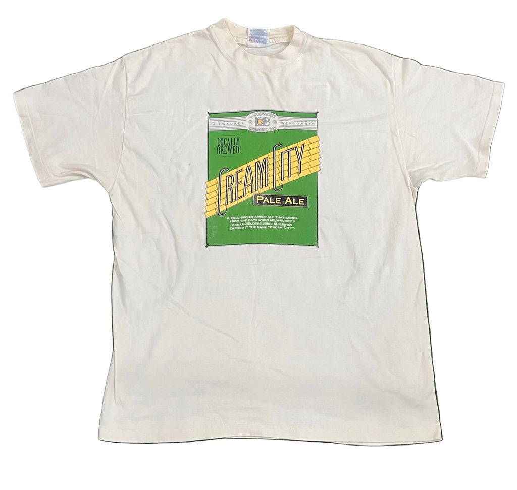 A white short-sleeve t-shirt featuring a vintage-style beer label graphic on the chest that reads 'Reamity Pale Ale' with green, yellow, and black colors.