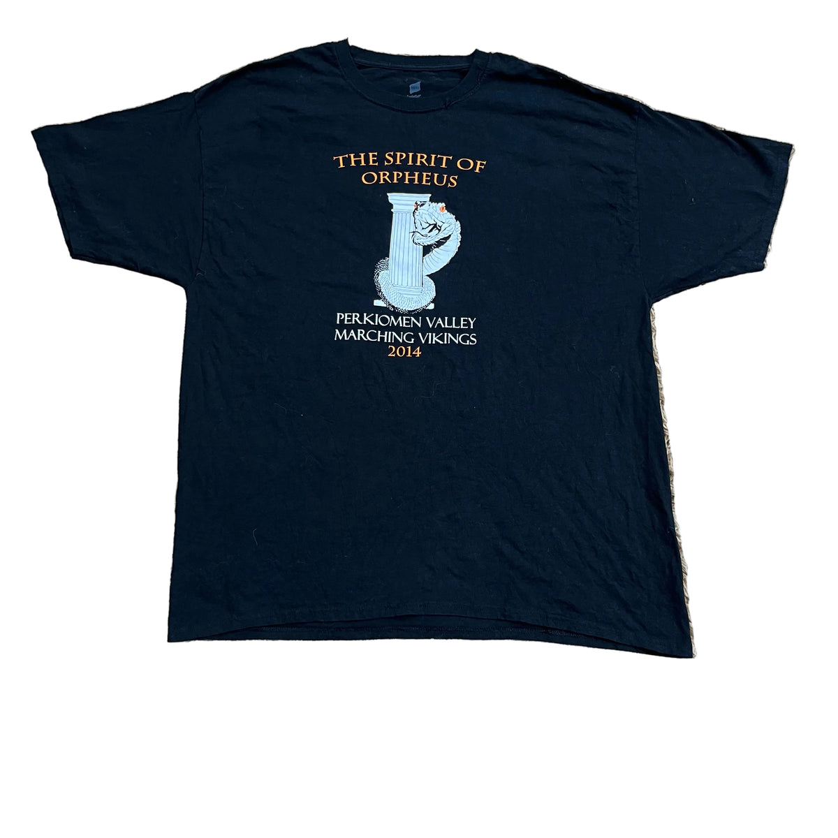A black short-sleeve t-shirt , featuring a white graphic of a cat and gold and white text that reads 'THE SPIRIT OF ORPHEUS' and 'PRAGMOKIMEN VALLEY MARCHING VIKINGS 2014'. A bare foot is visible at the bottom edge.