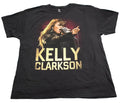 A black short-sleeve graphic T-shirt. The shirt features a large front print of Kelly Clarkson singing into a microphone, with 'KELLY CLARKSON' printed below in large gold letters.