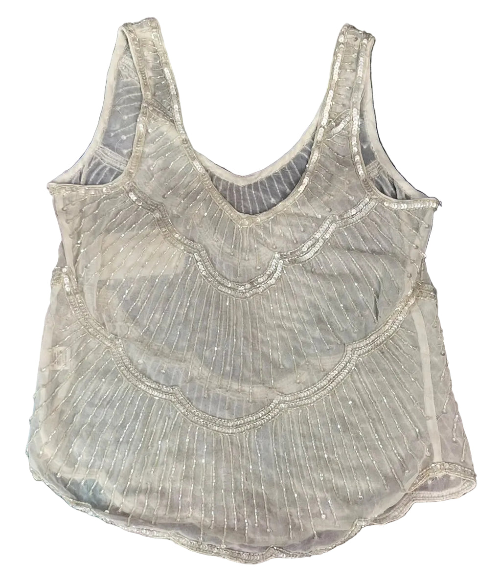 A sleeveless sheer mesh top with silver sequin and bead trim, 