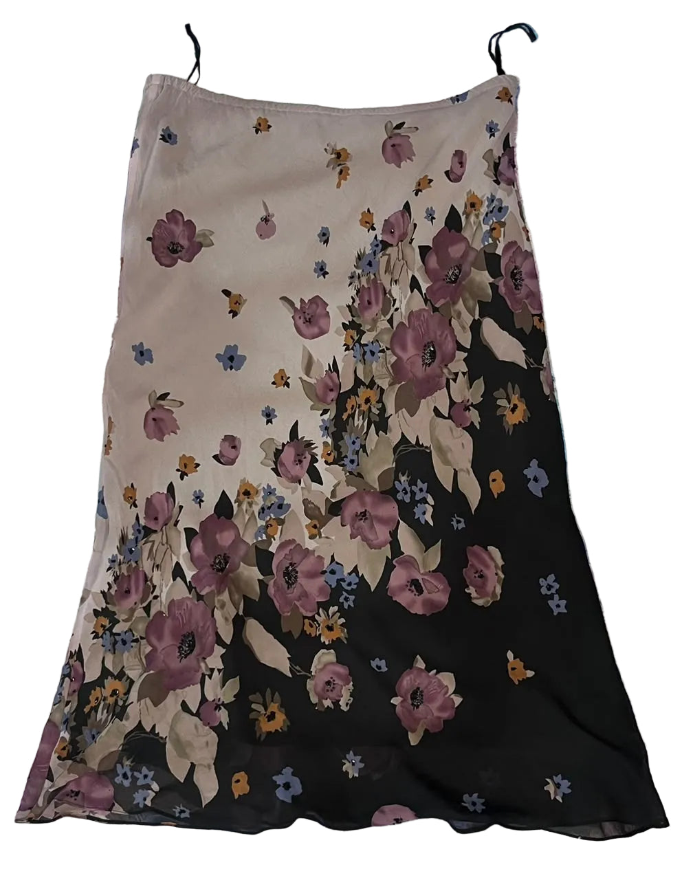 A sleeveless floral midi skirt with thin black shoulder straps,. The skirt features a split design: a light beige upper section with a small-scale floral print, and a black lower section with a larger,