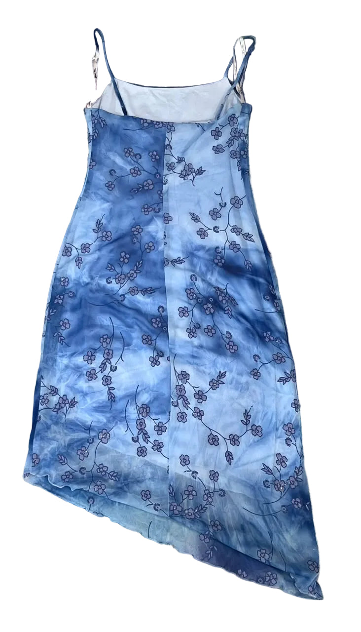 A blue tie-dye slip dress with a floral pattern, on  a white plain background
