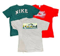 Three vintage graphic t-shirts a dark green Nike t-shirt, a red t-shirt with white text, and a heather gray Champion t-shirt with a colorful sponsor graphic.